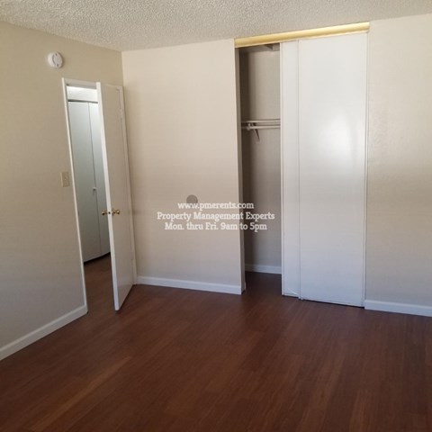 A room with a door and a clock on the wall.