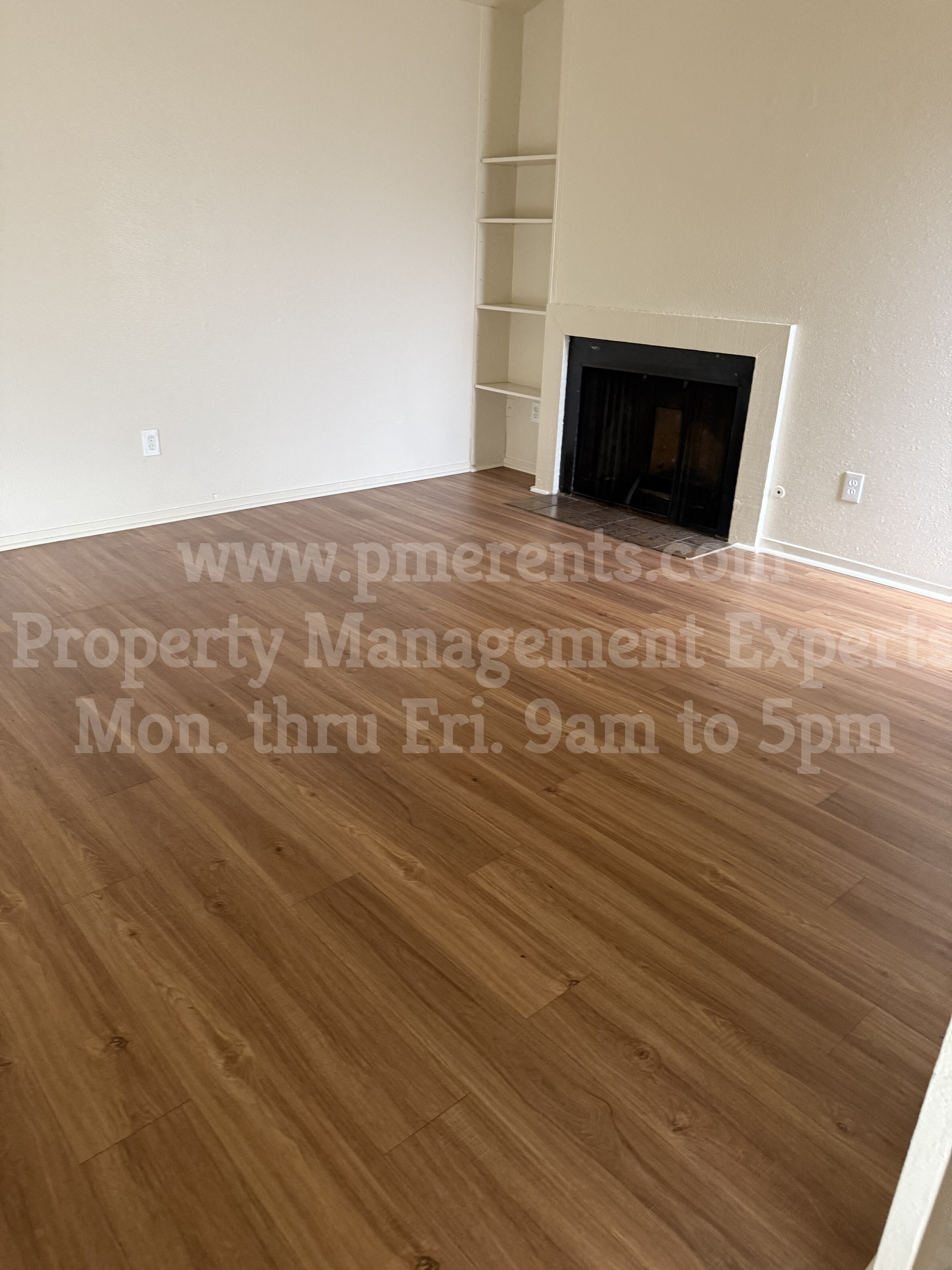 a living room with wood flooring and a fireplace
