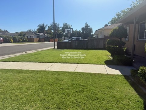 A residential street with a sign that says "www.jimwilson.com Men's Health Run in the Spot".