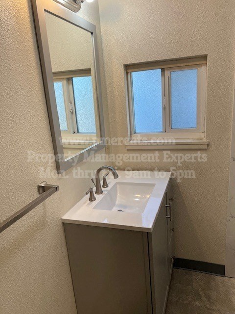 a small bathroom with a sink and a mirror