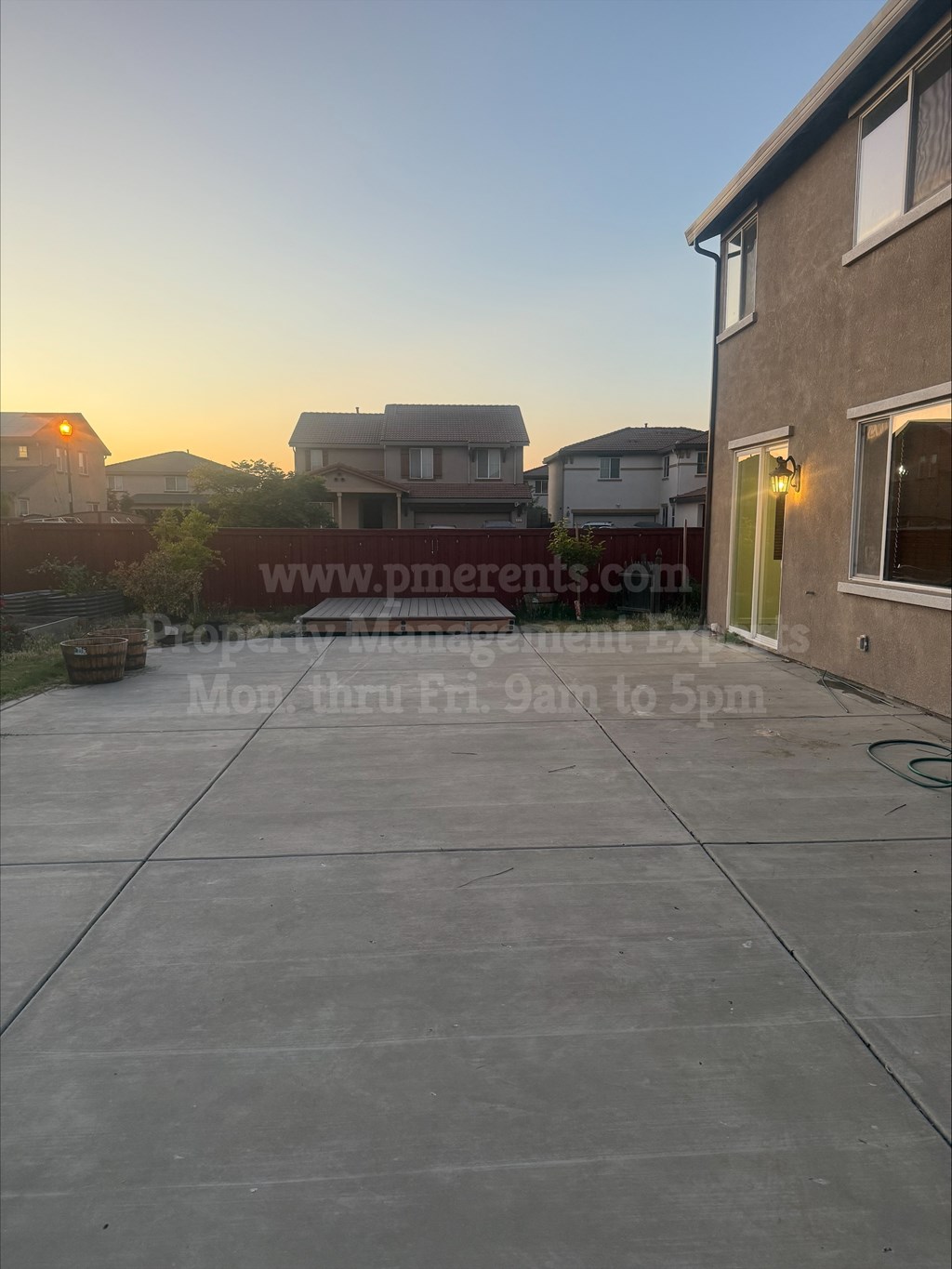 A residential area with a house and a sign for property management.