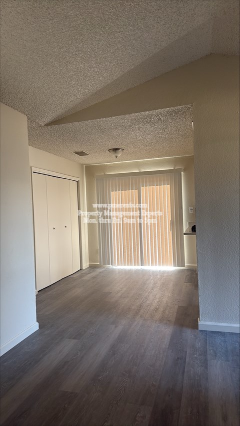 A long hallway with a door at the end.