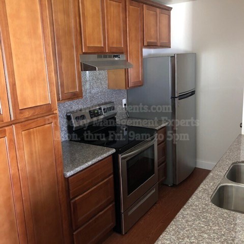 A kitchen with wooden cabinets and stainless steel appliances.