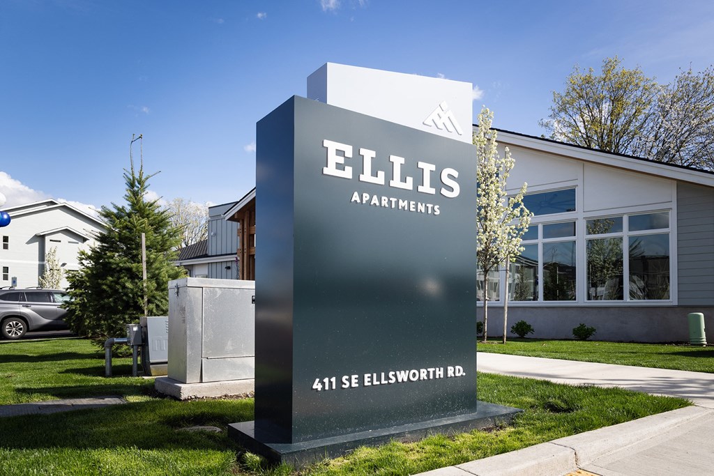 a sign for ellis apartments in front of a building