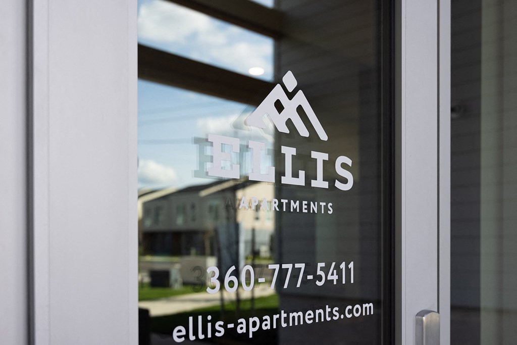 a window with the apartments logo on it