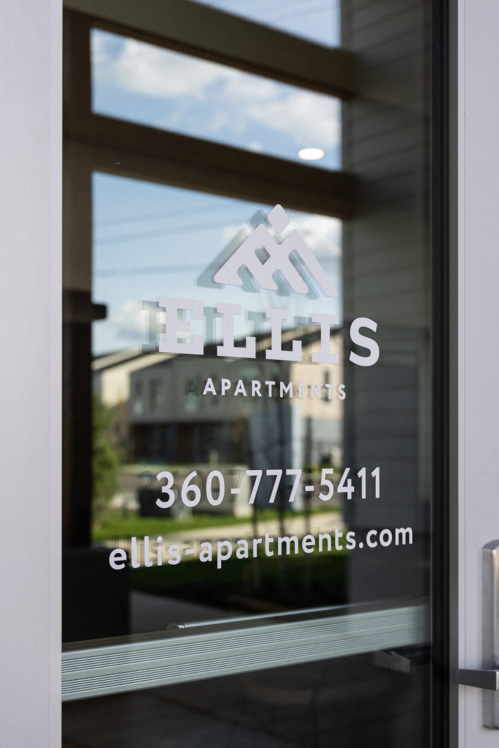 a glass door with the logo apartments on it