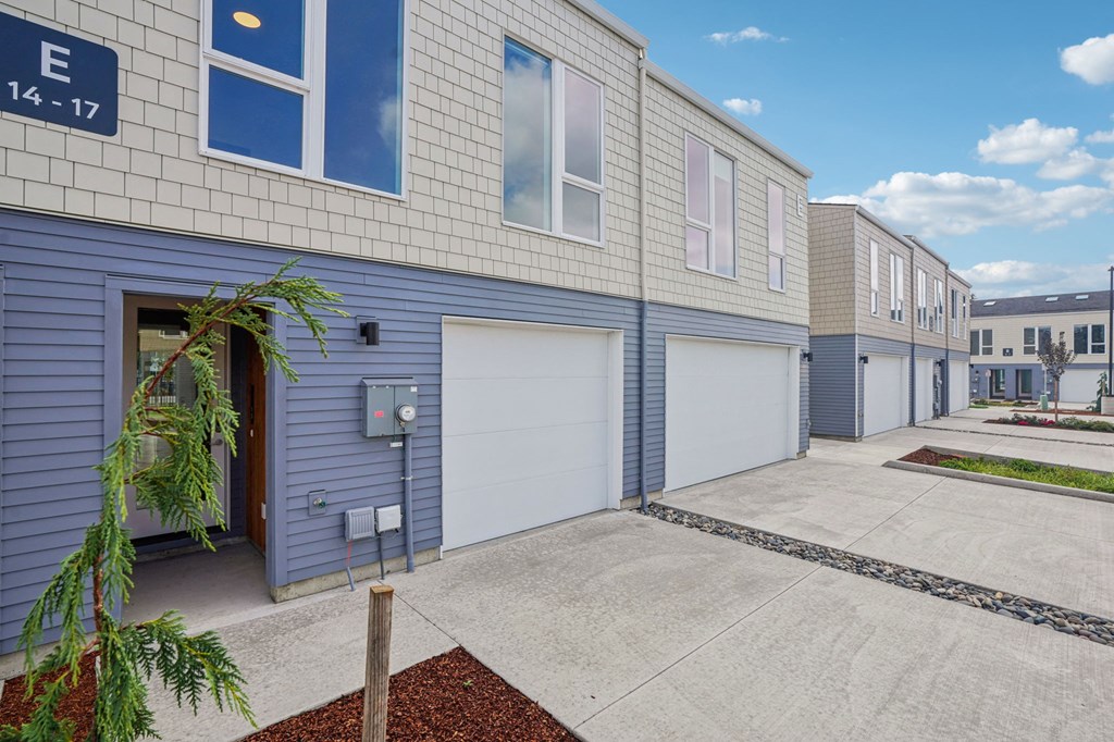 a blue and white building with two garage doors