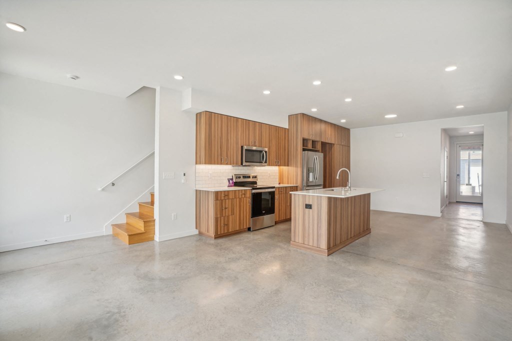 a kitchen with wooden cabinets and a counter top in a house