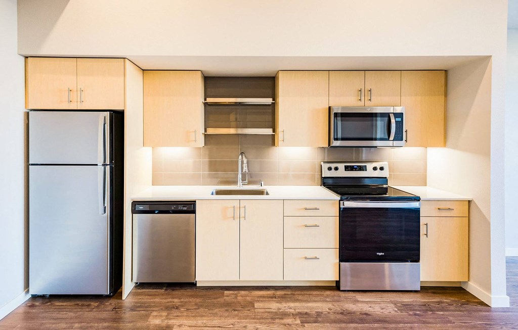 a kitchen with stainless steel appliances and white cabinets