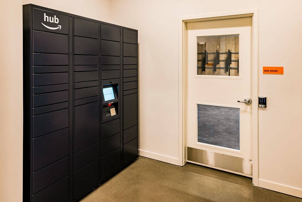 a set of black lockers in a room with a door