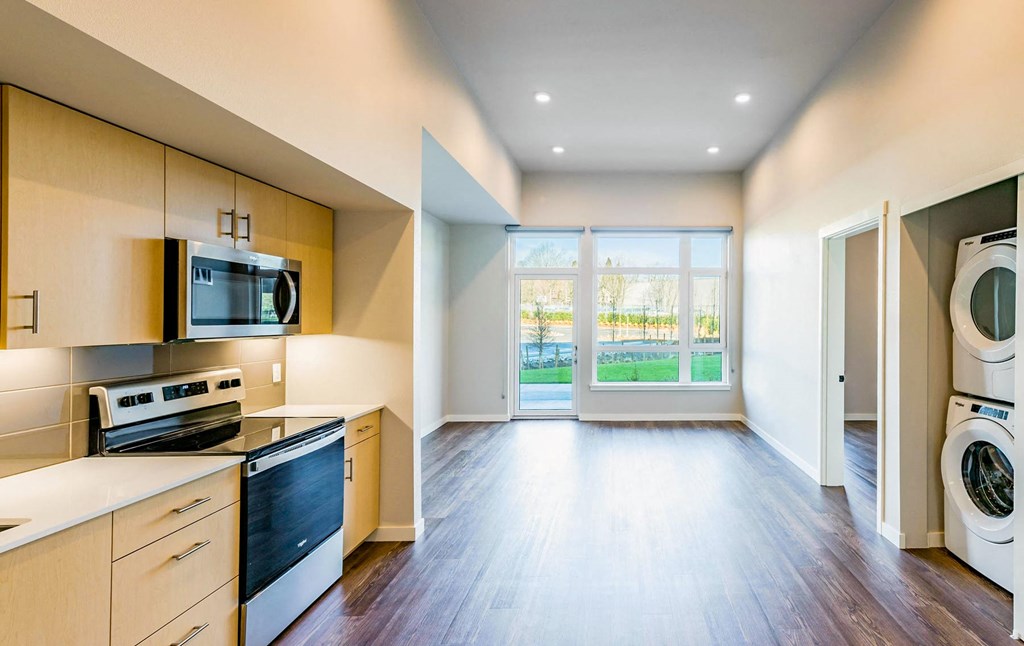 a kitchen with a washer and dryer and a window