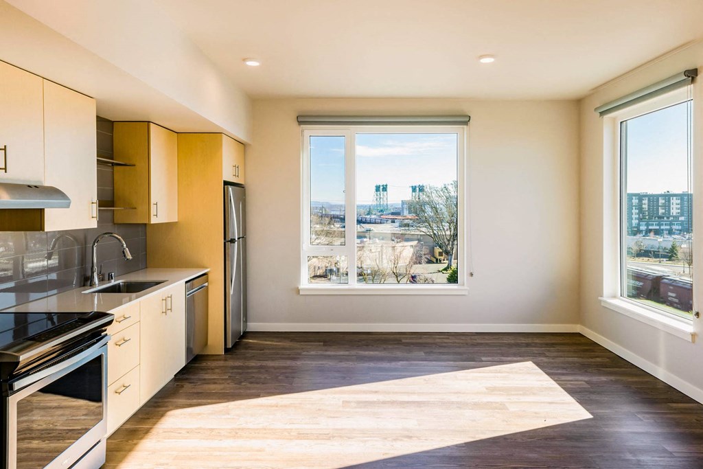 a kitchen with a window and a stove and a sink