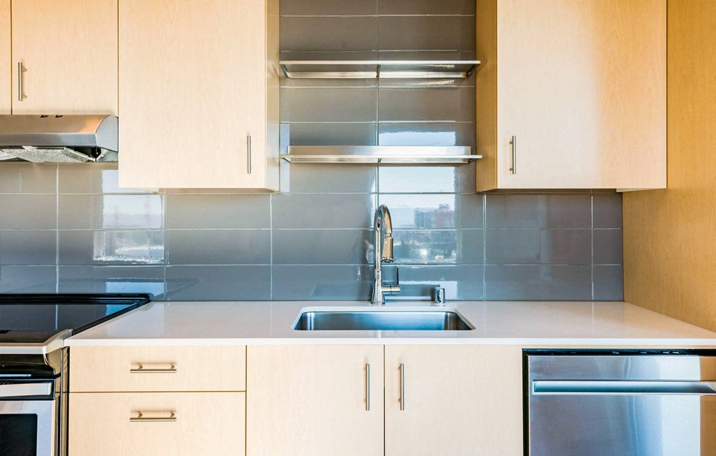 a small kitchen with white cabinets and a sink