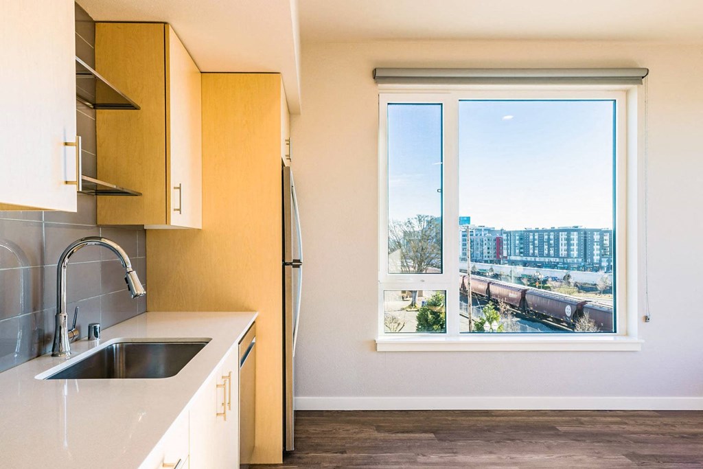 a kitchen with a large window and a sink