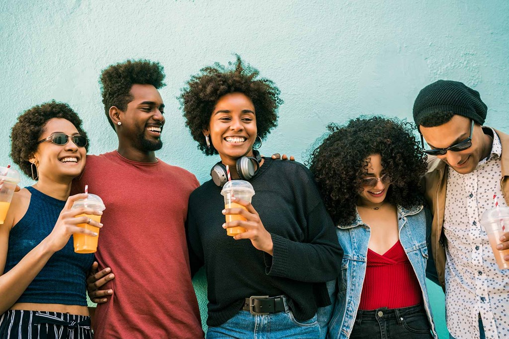 a group of friends posing for a picture with drinks
