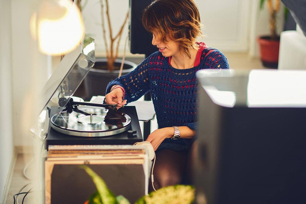 a woman cooking on a stove in a kitchen