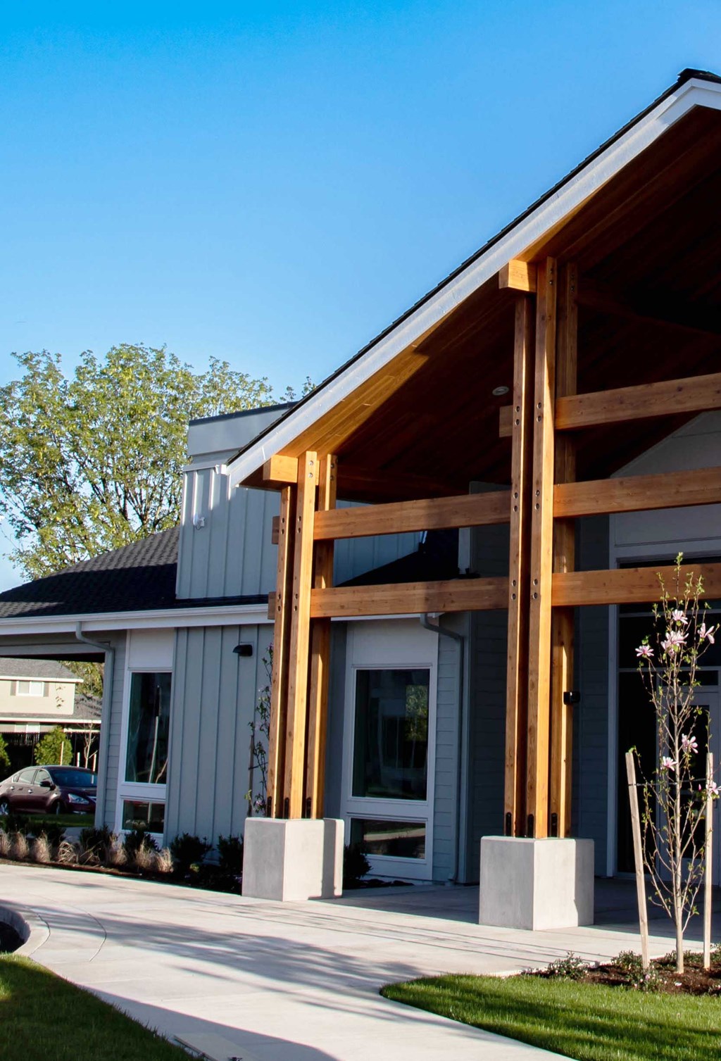the front of the house is clad in metal siding and wood beams