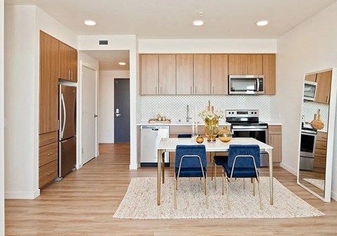 A kitchen with a table and chairs in the middle of the room.