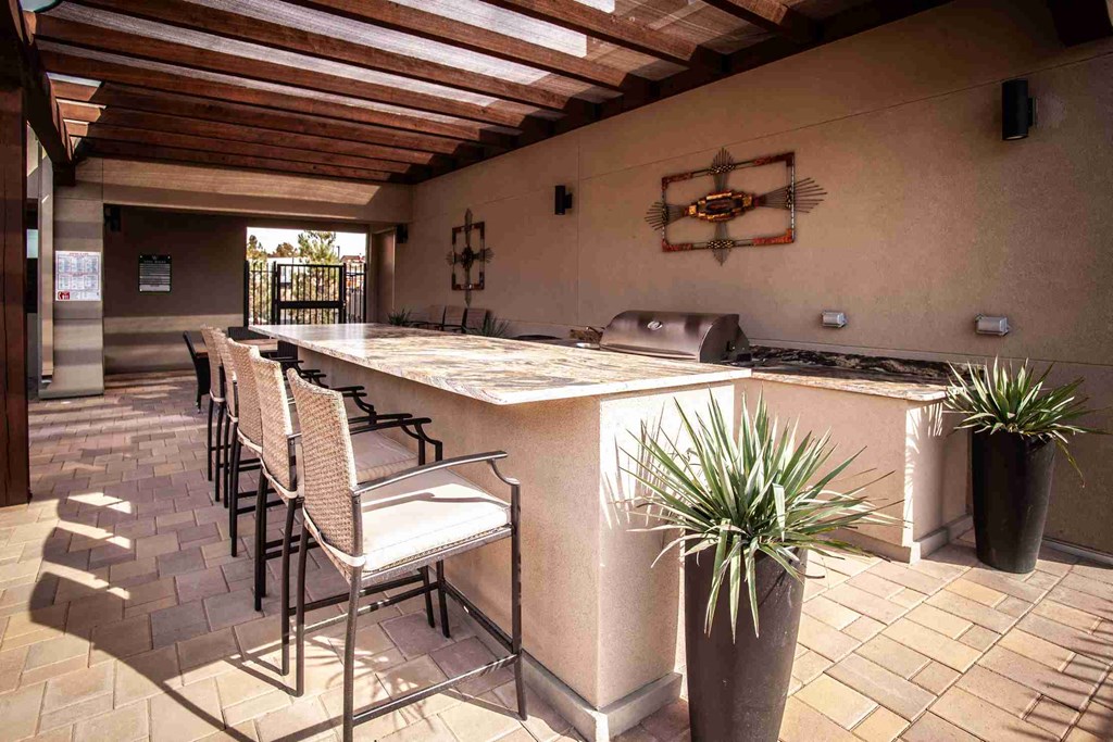 A kitchen with a table and chairs and a plant.