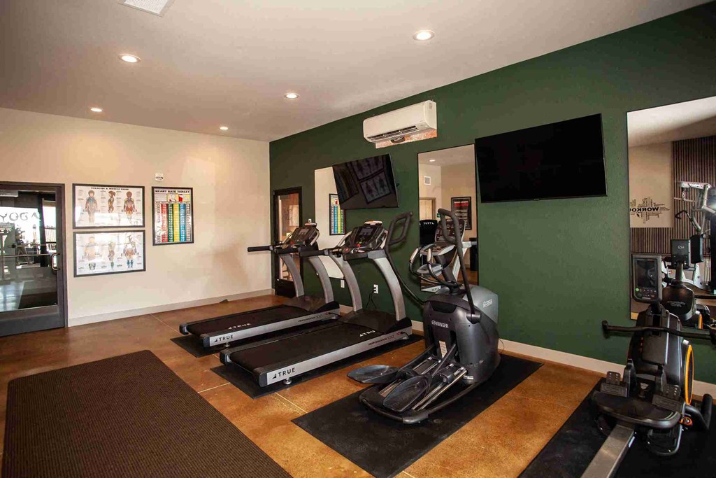 A gym with treadmills and exercise bikes.