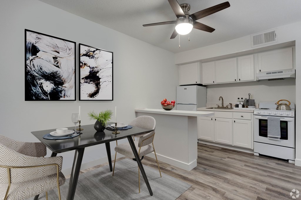 A modern kitchen with a dining table and chairs.