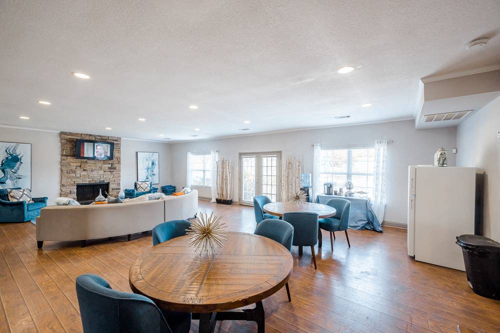 a living room and dining room with a table and chairs