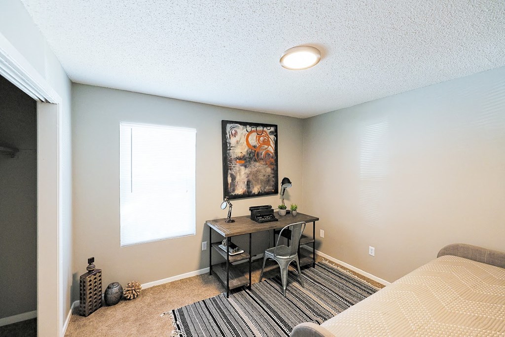 a bedroom with a desk and a window at Cedar Run Apartments, Tennessee
