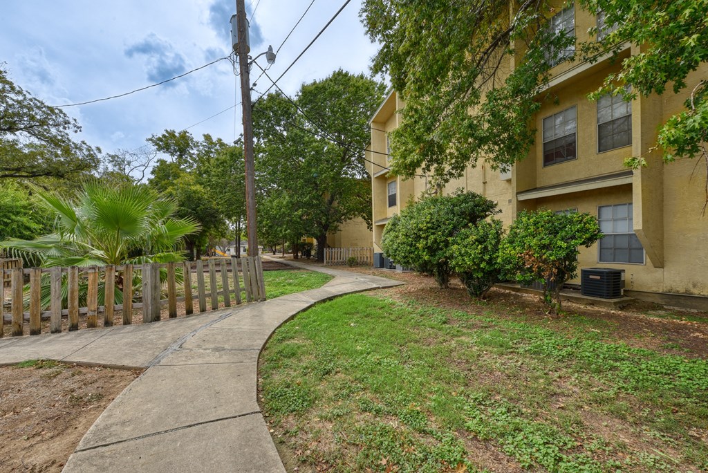 a sidewalk in front of an apartment building  at Mayfield Gardens, Texas, 78211