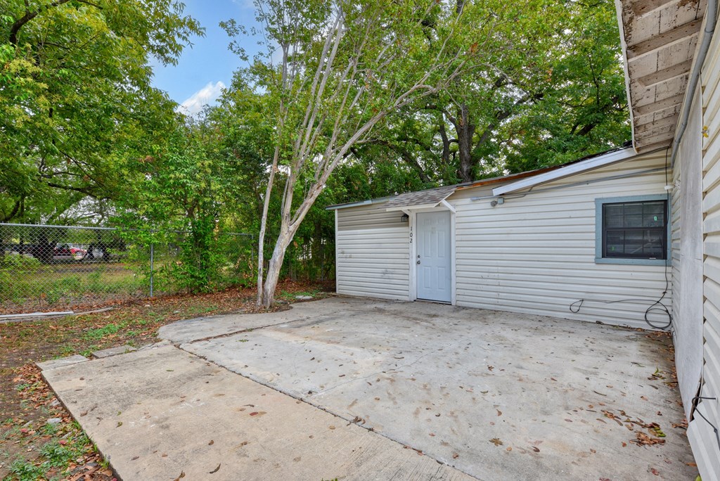 the driveway of a white house with a blue garage door  at Mayfield Gardens, San Antonio