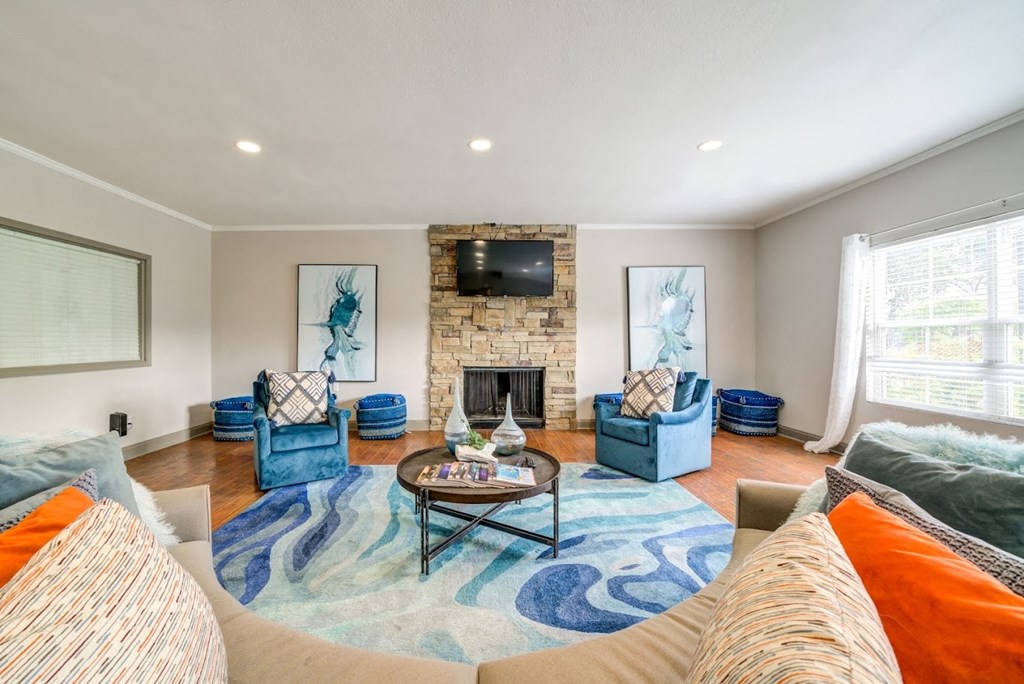 a living room with couches and chairs and a fireplace at Cedar Run Apartments, Tennessee 38115
