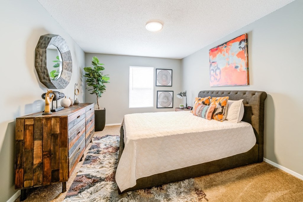 a bedroom with a bed and a dresser at Cedar Run Apartments, Memphis