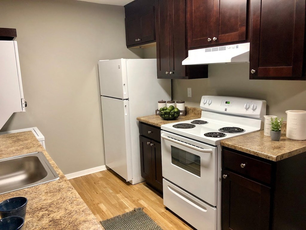 a kitchen with white appliances and wooden cabinets at Cedar Run Apartments, Memphis, 38115