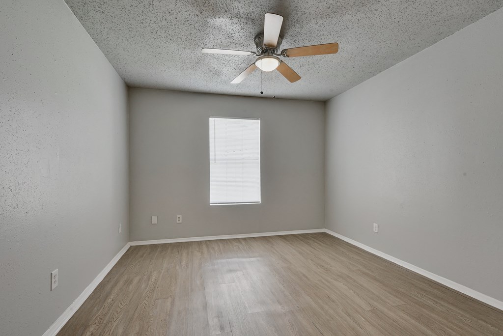 an empty room with wood floors and a ceiling fan at Eagle View Apartments, Pleasanton