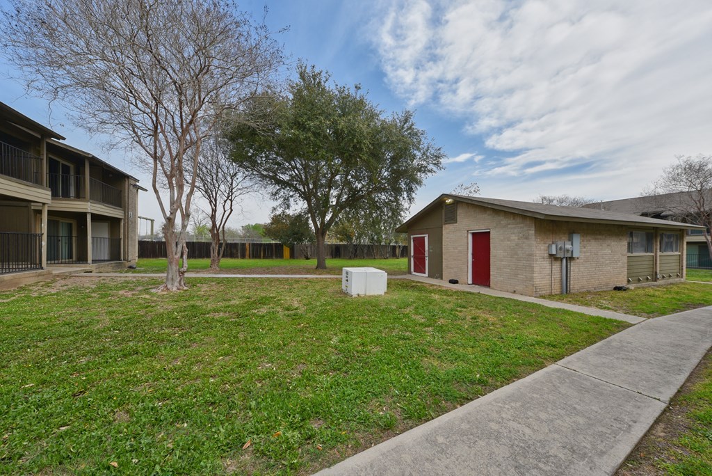 our apartments are located in a neighborhood with a sidewalk and grass at Eagle View Apartments, Pleasanton, TX