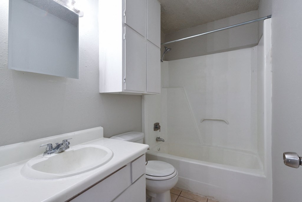 a bathroom with a sink toilet and a shower at Eagle View Apartments, Pleasanton, TX, 78064