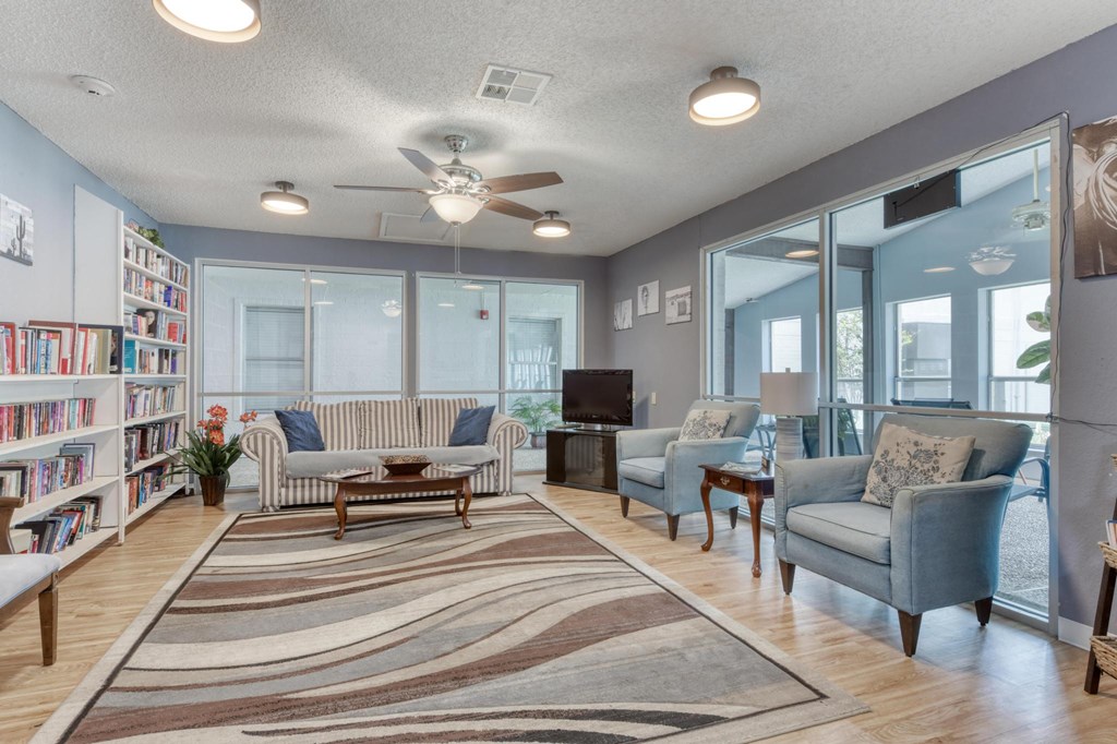 A living room with a striped rug and a blue couch.