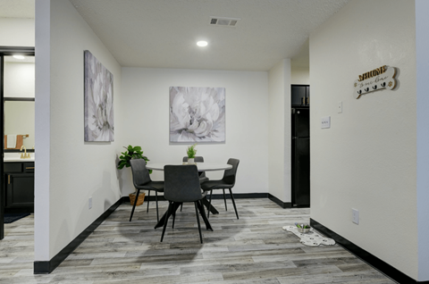A dining room with a table and chairs at Ranch at 1856 Apartments, San Marcos, TX