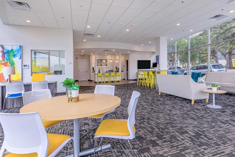 A brightly lit room with a round table and chairs.