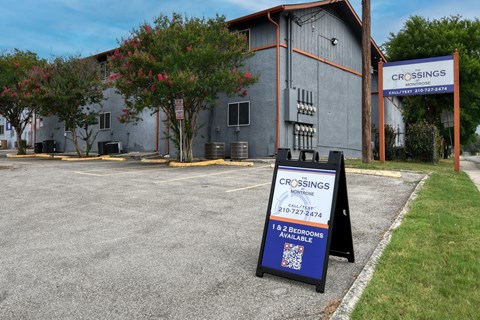 a sign in front of a building advertising car savings