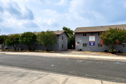 two buildings on the side of a street at The Crossings at Montrose Apartments, San Antonio, 78223