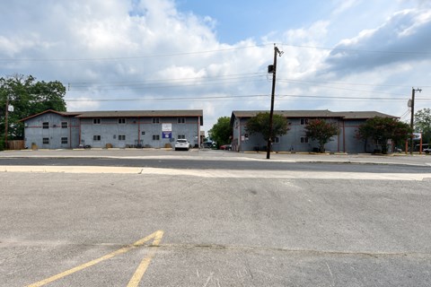 an apartment building on the corner of a street at The Crossings at Montrose Apartments, San Antonio, TX