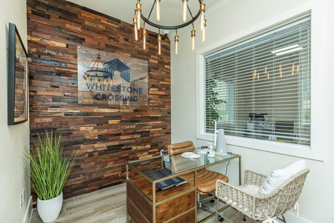 A reception area with a wooden wall and a sign that says "Whitestone Crossing".
