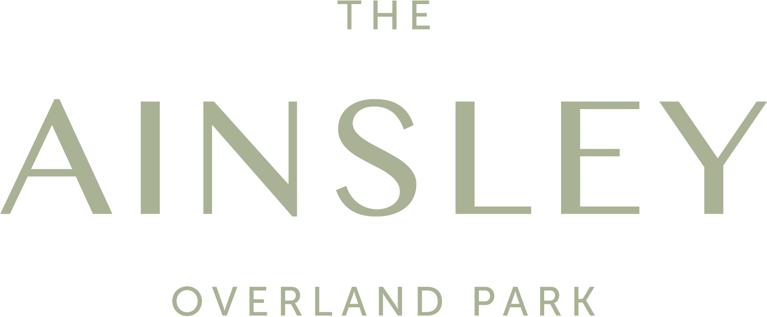 The image displays the text "THE AINSLEY OVERLAND PARK" in large, bold letters.