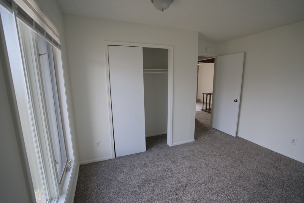 A room with a carpeted floor and white walls.