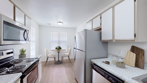 A modern kitchen with a dining table and chairs.