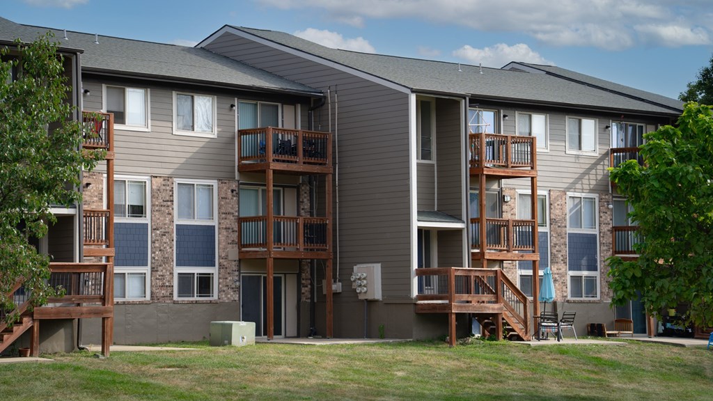 Apartment building with balconies and a clear sky in the background.