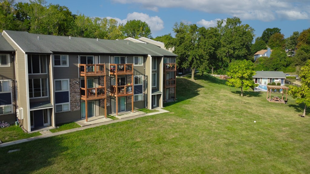 A large apartment complex with a green lawn in front.