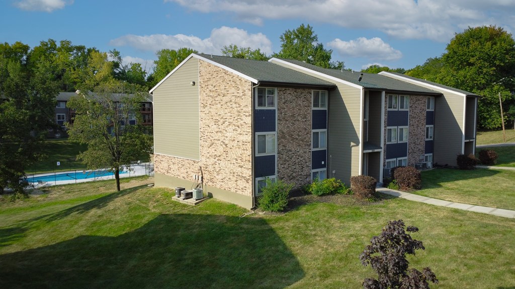 A building with a pool in the backyard.