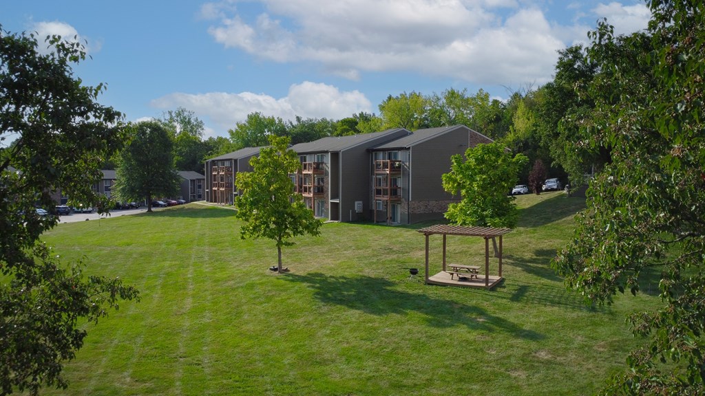 A modern building with a green lawn in front.