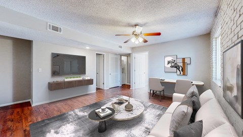 A living room with a white couch and a coffee table.